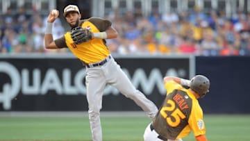 Jul 10, 2016; San Diego, CA, USA; World infielder Amed Rosario (left) throws to first base as USA runner Ryon Healy slides during the All Star Game futures baseball game at PetCo Park. Mandatory Credit: Gary A. Vasquez-USA TODAY Sports