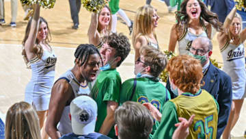 Feb 16, 2022; South Bend, Indiana, USA; Notre Dame Fighting Irish guard Blake Wesley (0) celebrates with the student section after Notre Dame defeated the Boston College Eagles in overtime at the Purcell Pavilion. Mandatory Credit: Matt Cashore-USA TODAY Sports
