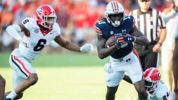 Auburn football tight end Rivaldo Fairweather (13) is tripped up by Georgia Bulldogs defensive back Malaki Starks (24) as Auburn Tigers take on Georgia Bulldogs at Jordan-Hare Stadium in Auburn, Ala., on Saturday, Sept. 30, 2023. Georgia Bulldogs defeated Auburn Tigers 27-20.