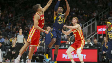 Mar 13, 2022; Atlanta, Georgia, USA; Indiana Pacers guard Buddy Hield (24) shoots past Atlanta Hawks guard Bogdan Bogdanovic (13) in the second quarter at State Farm Arena. Mandatory Credit: Brett Davis-USA TODAY Sports