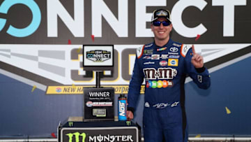 LOUDON, NH - SEPTEMBER 24: Kyle Busch, driver of the #18 M&M's Caramel Toyota, poses with the trophy in Victory Lane after winning the Monster Energy NASCAR Cup Series ISM Connect 300 at New Hampshire Motor Speedway on September 24, 2017 in Loudon, New Hampshire. (Photo by Sean Gardner/Getty Images)