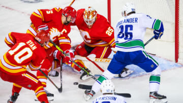 Jan 16, 2021; Calgary, Alberta, CAN; Calgary Flames goaltender Jacob Markstrom (25) makes a save against Vancouver Canucks left wing Nils Hoglander (36) during the first period at Scotiabank Saddledome. Mandatory Credit: Sergei Belski-USA TODAY Sports