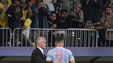 Manchester United's Norwegian manager Ole Gunnar Solskjaer (L) speaks with Manchester United's Portuguese striker Cristiano Ronaldo as he leaves the field following a substitution during the UEFA Champions League Group F football match between Young Boys and Manchester United at Wankdorf stadium in Bern, on September 14, 2021. (Photo by SEBASTIEN BOZON / AFP) (Photo by SEBASTIEN BOZON/AFP via Getty Images)