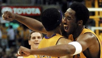 LOS ANGELES, UNITED STATES: Kobe Bryant (R) of the Los Angeles Lakers celebrates with Derek Fisher(L) during game four of their Western Conference Finals against the San Antonio Spurs 27 May 2001 at the Staples Center in Los Angeles, CA. The Lakers beat the Spurs 111-82 to sweep the best-of-seven series 4-0. AFP PHOTO/Mike NELSON (Photo credit should read MIKE NELSON/AFP via Getty Images)