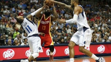 Oct 7, 2014; Dallas, TX, USA; Houston Rockets guard James Harden (13) is fouled by Dallas Mavericks guard Monta Ellis (11) as center Tyson Chandler (6) defends at American Airlines Center. Mandatory Credit: Matthew Emmons-USA TODAY Sports