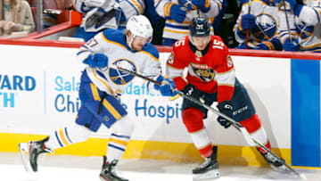 SUNRISE, FL - APRIL 8: Anton Lundell #15 of the Florida Panthers and Casey Mittelstadt #37 of the Buffalo Sabres battle for control the puck at the FLA Live Arena on April 8, 2022 in Sunrise, Florida. (Photo by Joel Auerbach/Getty Images)