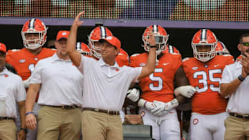 Clemson head coach Dabo Swinney gets excited with fans after rubbing HowardÕs Rock before the game in Clemson, S.C., September 18, 2021.Ncaa Football Georgia Tech At Clemson(Photo Courtesy of Imagn)