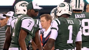 Aug 7, 2014; East Rutherford, NJ, USA; New York Jets quarterback Geno Smith (7) talks with quarterback Michael Vick (1) against the Indianapolis Colts during the second quarter at MetLife Stadium. Mandatory Credit: Adam Hunger-USA TODAY Sports