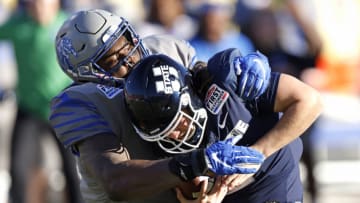 DALLAS, TX - DECEMBER 27: Cooper Legas #5 of the Utah State Aggies is sacked bye Cam'Ron Jackson #10 of the Memphis Tigers in the first half of the SERVPRO First Responder Bowl at Gerald J. Ford Stadium on December 27, 2022 in Dallas, Texas. (Photo by Ron Jenkins/Getty Images)