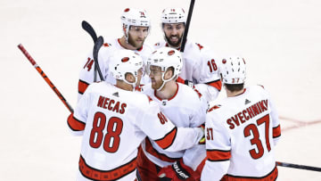 TORONTO, ONTARIO - AUGUST 13: Dougie Hamilton #19 of the Carolina Hurricanes is congratulated by his teammates after scoring a goal against the Boston Bruins during the third period in Game Two of the Eastern Conference First Round during the 2020 NHL Stanley Cup Playoffs at Scotiabank Arena on August 13, 2020 in Toronto, Ontario. (Photo by Elsa/Getty Images)