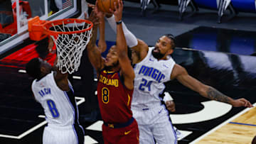Jan 4, 2021; Orlando, Florida, USA; Cleveland Cavaliers forward Lamar Stevens (8) drives to the hoop between Orlando Magic guard Dwayne Bacon (8) and center Khem Birch (24) during the second half at Amway Center. Mandatory Credit: Reinhold Matay-USA TODAY Sports
