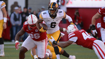 LINCOLN, NE - NOVEMBER 24: Wide receiver Ihmir Smith-Marsette #6 of the Iowa Hawkeyes runs from defensive lineman Carlos Davis #96 of the Nebraska Cornhuskers and defensive back Joshua Kalu #46 at Memorial Stadium on November 24, 2017 in Lincoln, Nebraska. (Photo by Steven Branscombe/Getty Images)
