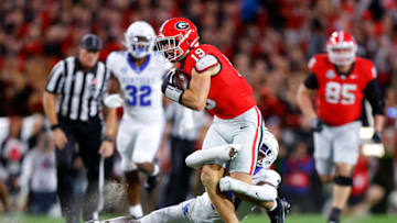 ATHENS, GEORGIA - OCTOBER 7: Brock Bowers #19 of the Georgia Bulldogs is tackled by Maxwell Hairston #31 of the Kentucky Wildcats during the first quarter at Sanford Stadium on October 7, 2023 in Athens, Georgia. (Photo by Todd Kirkland/Getty Images)