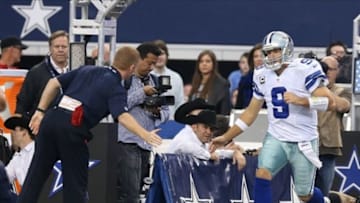 Dec 15, 2013; Arlington, TX, USA; Dallas Cowboys quarterback Tony Romo (9) claps hands with head coach Jason Garrett as he is introduced prior to the game against the Green Bay Packers at AT