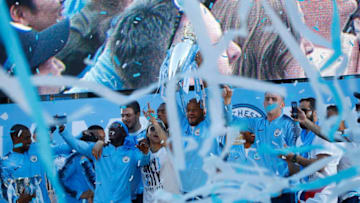 MANCHESTER, ENGLAND - MAY 14: Vincent Kompany of Manchester City lifts the Premier League Trophy during the Manchester City Trophy Parade in Manchester city centre on May 14, 2018 in Manchester, England. (Photo by Lynne Cameron/Getty Images)