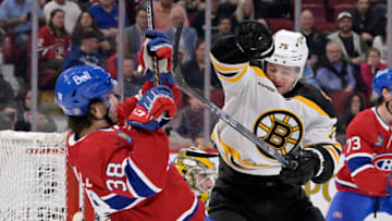 Apr 13, 2023; Montreal, Quebec, CAN; Boston Bruins defenseman Connor Clifton (75) checks Montreal Canadiens forward Joel Teasdale (38) away from the crease during the second period at the Bell Centre. Mandatory Credit: Eric Bolte-USA TODAY Sports