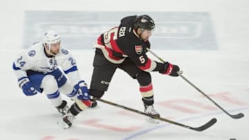 Mar 3, 2016; Ottawa, Ontario, CAN; Tampa Bay Lightning right wing Ryan Callahan (24) and Ottawa Senators defenseman Cody Ceci (5) battle for the puck in the third period at the Canadian Tire Centre. The Lightning defeated the Senators 4-1. Mandatory Credit: Marc DesRosiers-USA TODAY Sports