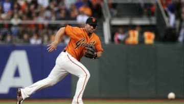 Jul 25, 2014; San Francisco, CA, USA; San Francisco Giants second baseman Dan Uggla (22) chases a ground ball in the fourth inning of their MLB baseball game with the Los Angeles Dodgers at AT&T Park. Mandatory Credit: Lance Iversen-USA TODAY Sports