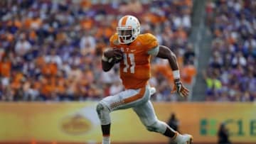 Jan 1, 2016; Tampa, FL, USA; Tennessee Volunteers quarterback Joshua Dobbs (11) runs the ball in for a touchdown against the Northwestern Wildcats during the second half in the 2016 Outback Bowl at Raymond James Stadium. Tennessee Volunteers defeated the Northwestern Wildcats 45-6. Mandatory Credit: Kim Klement-USA TODAY Sports