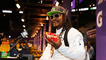 PHOENIX, AZ - JANUARY 27: Marshawn Lynch #24 of the Seattle Seahawks eats Skittles as he addresses the media at Super Bowl XLIX Media Day Fueled by Gatorade inside U.S. Airways Center on January 27, 2015 in Phoenix, Arizona. (Photo by Christian Petersen/Getty Images)