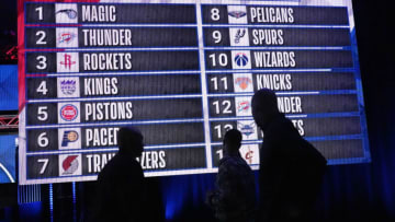 People look at the draft lottery order after the 2022 NBA Draft Lottery at McCormick Place. Mandatory Credit: David Banks-USA TODAY Sports
