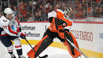 PHILADELPHIA, PA - MARCH 14: Carter Hart #79 of the Philadelphia Flyers goes behind his net to play the puck against T.J. Oshie #77 of the Washington Capitals on March 14, 2019 at the Wells Fargo Center in Philadelphia, Pennsylvania. (Photo by Len Redkoles/NHLI via Getty Images)