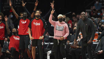 Jan 5, 2022; Portland, Oregon, USA; Portland Trail Blazers guard Damian Lillard (0), right, celebrates a three point basket by a teammate during the second against the Miami Heat at Moda Center. The Heat won the game 115-109. Mandatory Credit: Troy Wayrynen-USA TODAY Sports