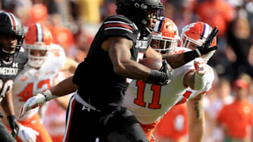 COLUMBIA, SOUTH CAROLINA - NOVEMBER 30: Rico Dowdle #5 of the South Carolina Gamecocks runs with the ball against Isaiah Simmons #11 of the Clemson Tigers during their game at Williams-Brice Stadium on November 30, 2019 in Columbia, South Carolina. (Photo by Streeter Lecka/Getty Images)