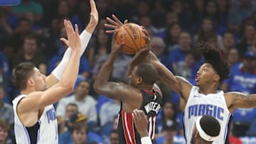 The Miami Heat's Dion Waiters (11) drives into the Orlando Magic's Nikola Vucevic, left, Elfrid Payton, top right, and Terrence Ross (31) at the Amway Center in Orlando, Fla., on Wednesday, Oct. 18, 2017. The Magic won, 116-109. (Stephen M. Dowell/Orlando Sentinel/TNS via Getty Images)