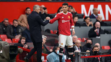 Manchester United's Norwegian manager Ole Gunnar Solskjaer (L) shakes hands with Manchester United's Portuguese striker Cristiano Ronaldo as he comes off the substitutes bench during the English Premier League football match between Manchester United and Everton at Old Trafford in Manchester, north west England, on October 2, 2021. - RESTRICTED TO EDITORIAL USE. No use with unauthorized audio, video, data, fixture lists, club/league logos or 'live' services. Online in-match use limited to 120 images. An additional 40 images may be used in extra time. No video emulation. Social media in-match use limited to 120 images. An additional 40 images may be used in extra time. No use in betting publications, games or single club/league/player publications. (Photo by Oli SCARFF / AFP) / RESTRICTED TO EDITORIAL USE. No use with unauthorized audio, video, data, fixture lists, club/league logos or 'live' services. Online in-match use limited to 120 images. An additional 40 images may be used in extra time. No video emulation. Social media in-match use limited to 120 images. An additional 40 images may be used in extra time. No use in betting publications, games or single club/league/player publications. / RESTRICTED TO EDITORIAL USE. No use with unauthorized audio, video, data, fixture lists, club/league logos or 'live' services. Online in-match use limited to 120 images. An additional 40 images may be used in extra time. No video emulation. Social media in-match use limited to 120 images. An additional 40 images may be used in extra time. No use in betting publications, games or single club/league/player publications. (Photo by OLI SCARFF/AFP via Getty Images)