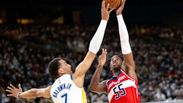 TOPSHOT - Golden State Warriors' Patrick Baldwin Jr. fights for the ball with Washington Wizards' Delon Wright (Photo by PHILIP FONG/AFP via Getty Images)