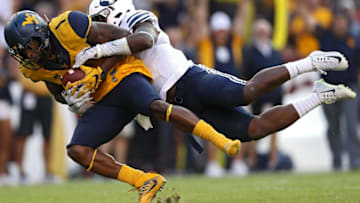LANDOVER, MD - SEPTEMBER 24: Wide receiver Shelton Gibson #1 of the West Virginia Mountaineers is tackled by defensive back Dayan Lake #5 of the Brigham Young Cougars during the second half at FedExField on September 24, 2016 in Landover, Maryland. (Photo by Patrick Smith/Getty Images)