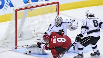 Dec 1, 2016; Glendale, AZ, USA; Los Angeles Kings goalie Jeff Zatkoff (37) makes a save on Arizona Coyotes center Tobias Rieder (8) as defenseman Drew Doughty (8) defends during the second period at Gila River Arena. Mandatory Credit: Matt Kartozian-USA TODAY Sports