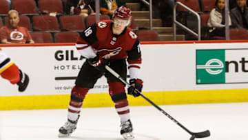 GLENDALE, AZ - MARCH 19: Arizona Coyotes center Christian Dvorak (18) looks to pass during the NHL hockey game between the Calgary Flames and the Arizona Coyotes on March 19, 2018 at Gila River Arena in Glendale, Arizona. (Photo by Kevin Abele/Icon Sportswire via Getty Images)