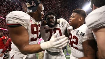 ATLANTA, GA - JANUARY 08: Raekwon Davis #99 and Alex Leatherwood #70 of the Alabama Crimson Tide celebrate after beating the Georgia Bulldogs in overtime to win the CFP National Championship presented by AT&T at Mercedes-Benz Stadium on January 8, 2018 in Atlanta, Georgia. The Alabama Crimson Tide won 26-23. (Photo by Christian Petersen/Getty Images)