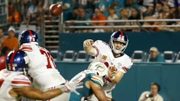 Dec 14, 2015; Miami Gardens, FL, USA; New York Giants quarterback Eli Manning (10) is tackled by Miami Dolphins defensive end Olivier Vernon (50) during the second half at Sun Life Stadium. Mandatory Credit: Steve Mitchell-USA TODAY Sports