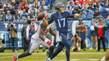 NASHVILLE, TENNESSEE - OCTOBER 27: Quarterback Ryan Tannehill #17 of the Tennessee Titans rolls out to throw a pass against Jason Pierre-Paul #90 of the Tampa Bay Buccaneers during the first half at Nissan Stadium on October 27, 2019 in Nashville, Tennessee. (Photo by Frederick Breedon/Getty Images)