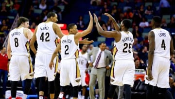 Mar 31, 2016; New Orleans, LA, USA; New Orleans Pelicans guard Tim Frazier (2) celebrates with forward Luke Babbitt (8), center Alexis Ajinca (42), guard Jordan Hamilton (25), and forward James Ennis (4) after scoring during the second half against the Denver Nuggets at the Smoothie King Center. The Pelicans won 101-95. Mandatory Credit: Derick E. Hingle-USA TODAY Sports