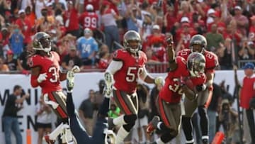 November 11, 2012; Tampa, FL, USA; Tampa Bay Buccaneers cornerback LeQuan Lewis (30) is congratulated by free safety Ronde Barber (20) after he intercepted the ball from San Diego Chargers wide receiver Danario Alexander (84) during the second half at Raymond James Stadium. Tampa Bay Buccaneers defeated the San Diego Chargers 34-24. Mandatory Credit: Kim Klement-USA TODAY Sports