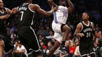 Jan 31, 2014; Brooklyn, NY, USA; Oklahoma City Thunder point guard Reggie Jackson (15) shoots the ball in front of Brooklyn Nets shooting guard Joe Johnson (7) and small forward Paul Pierce (34) in the first half at Barclays Center. Mandatory Credit: Noah K. Murray-USA TODAY Sports