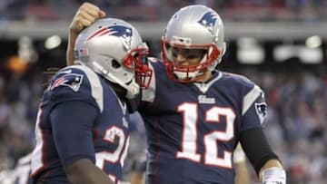 Nov 23, 2014; Foxborough, MA, USA; New England Patriots quarterback Tom Brady (12) congratulates running back LeGarrette Blount (29) on his touchdown during the fourth quarter against the Detroit Lions at Gillette Stadium. The Patriots defeated the Lions 34-9. Mandatory Credit: Stew Milne-USA TODAY Sports