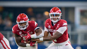 Arkansas Razorbacks quarterback KJ Jefferson hands off to running back Raheim Sanders. USA Today.