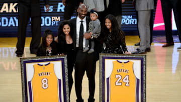 LOS ANGELES, CA - DECEMBER 18: Kobe Bryant poses with his family at halftime after both his #8 and #24 Los Angeles Lakers jerseys are retired at Staples Center on December 18, 2017 in Los Angeles, California. NOTE TO USER: User expressly acknowledges and agrees that, by downloading and or using this photograph, User is consenting to the terms and conditions of the Getty Images License Agreement. (Photo by Maxx Wolfson/Getty Images)