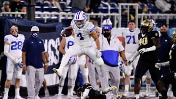 BOCA RATON, FLORIDA - DECEMBER 22: Lopini Katoa #4 of the Brigham Young Cougars leaps over against the Central Florida Knights at FAU Stadium on December 22, 2020 in Boca Raton, Florida. (Photo by Mark Brown/Getty Images)