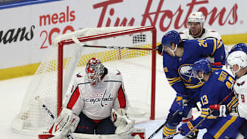 Jan 14, 2021; Buffalo, New York, USA; Washington Capitals goaltender Ilya Samsonov (30) makes a save on Buffalo Sabres center Dylan Cozens (24) during the second period at KeyBank Center. Mandatory Credit: Timothy T. Ludwig-USA TODAY Sports