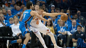 OKLAHOMA CITY, OK - OCTOBER 19: Alex Abrines #8 of the Oklahoma City Thunder and Kristaps Porzingis #6 of the New York Knicks battle for the ball during the first half of a NBA game at the Chesapeake Energy Arena on October 19, 2017 in Oklahoma City, Oklahoma. (Photo by J Pat Carter/Getty Images)