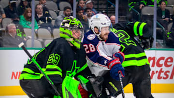Dec 2, 2021; Dallas, Texas, USA; Dallas Stars center Radek Faksa (12) and goaltender Jake Oettinger (29) defend against Columbus Blue Jackets right wing Oliver Bjorkstrand (28) during the third period at the American Airlines Center. Mandatory Credit: Jerome Miron-USA TODAY Sports