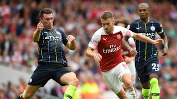 LONDON, ENGLAND - AUGUST 12: Aaron Ramsey of Arsenal is challenged by Aymeric Laporte of Manchester City during the Premier League match between Arsenal FC and Manchester City at Emirates Stadium on August 12, 2018 in London, United Kingdom. (Photo by Michael Regan/Getty Images)