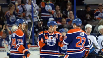 Sep 29, 2014; Edmonton, Alberta, CAN; Edmonton Oilers left wing Taylor Hall (4) celebrates a goal with teammates against the Winnipeg Jets in the second period at Rexall Place. Mandatory Credit: Chris LaFrance-USA TODAY Sports