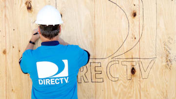 NORTH LAS VEGAS, NV - APRIL 22: DirecTV CEO Mike White signs a wall as DirectTV volunteers build homes for Southern Nevada families with Habitat for Humanity on April 22, 2013 in North Las Vegas, Nevada. (Photo by Isaac Brekken/Getty Images for DirecTV)